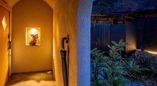 a umbrella hanging on the side of a wall at Yufuin Luxury Villa -zakuro- in Yufuin