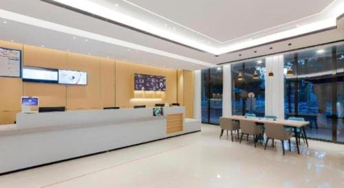 a lobby with a cafeteria with tables and chairs at City Comfort Inn Wuhan Ikea in Wuhan