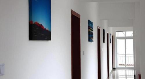 a room with a bunch of pictures on a wall at Shell Linzhi Bayi Area G318 Shuangyong Road Hotel in Nyingchi
