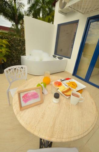 a table with food and a painting on it at Astara by Fernando Gaitan in Anapoima