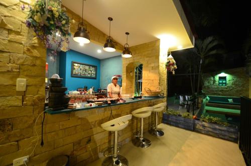 a person standing in a kitchen with a counter at Astara by Fernando Gaitan in Anapoima