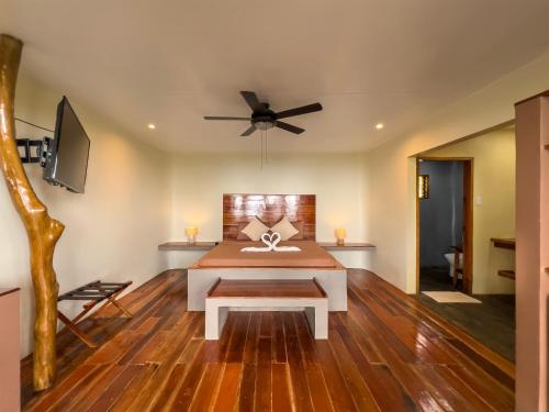 a living room with a table and a ceiling fan at Nakabalo Guesthouse & Restaurant in Siquijor