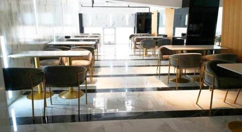 a dining room with tables and chairs in a building at Han Hotel Meisu Xi'an Longshouyuan Shenglong Plaza in Xi'an