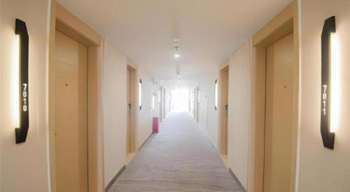a hallway of a building with a long corridor at City Comfort Inn Shantou Daxue Road in Shantou