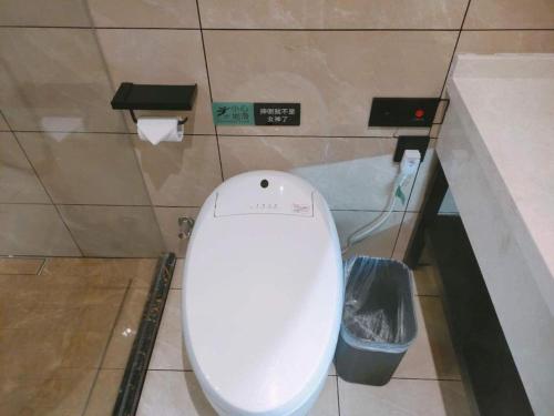 a bathroom with a white toilet in a stall at Xana Lite Hotelle Yan'an Baota Mountain in Yan'an