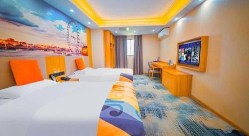 a hotel room with two beds and a flat screen tv at Shell Hotel Wuhu Jiujiang District Daqiao Town Huashan Road in Wuhu