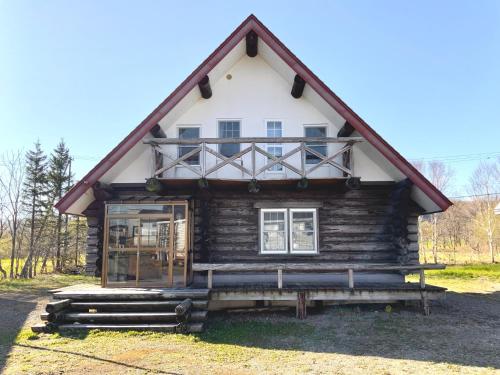 a log cabin in the woods with a porch at Mashuko Youth Hostel - Vacation STAY 01024v in Teshikaga