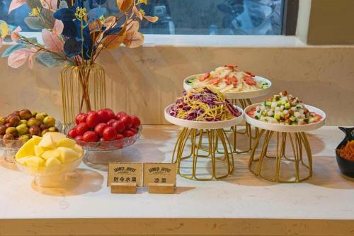 a table with three plates of different types of food at James Joyce Coffetel· Xianyang Renmin Road Central Square Store in Xianyang