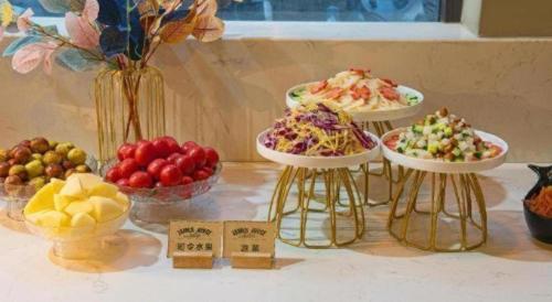 a table with plates of different types of food at James Joyce Coffetel· Xianyang Renmin Road Central Square Store in Xianyang
