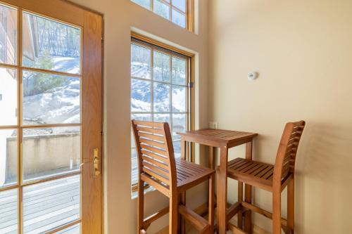 two chairs and a table in a room with a window at Vail View by AvantStay Minutes from Beaver Creek in Dowds Junction