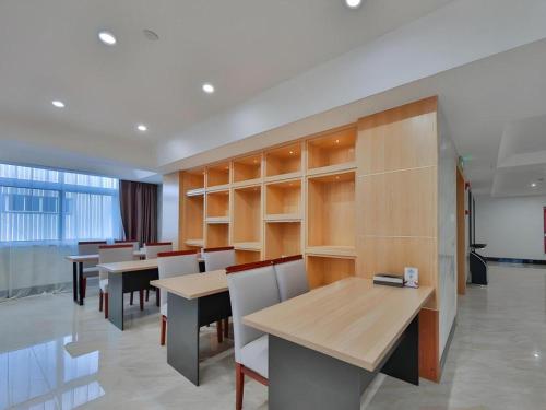 a dining room with tables and chairs in a building at Green Tree Inn Express Zhejiang Zhoushan Xincheng Zheda in Zhoushan