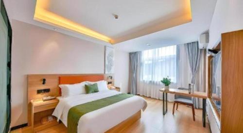 a hotel room with a large bed and a window at Green Tree Inn Express Zhejiang Zhoushan Xincheng Zheda in Zhoushan