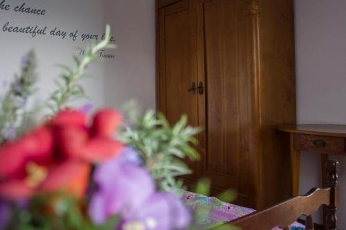 a room with a table with flowers and a wooden door at Holiday Home Bukovac in Klimno