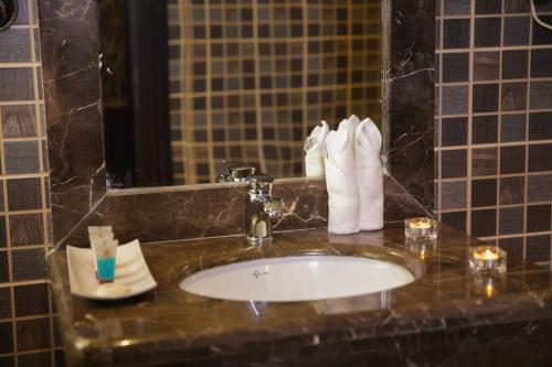 a bathroom with a sink and towels on a counter at Dalin Hotel in Riyadh