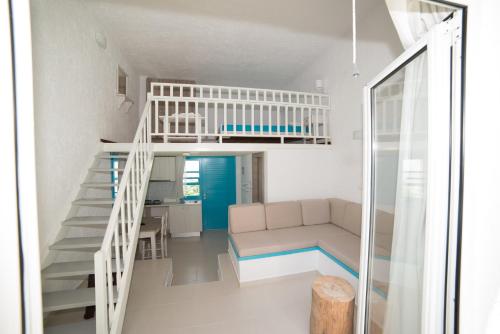 a living room with a staircase and a couch at Villa Stella Apartments by Estia in Stalís