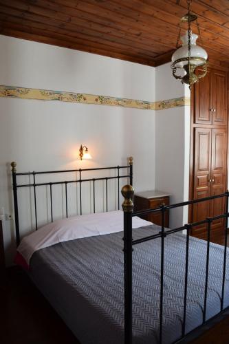 a bedroom with a bed and a wooden ceiling at Vera's Traditional House in Zagora