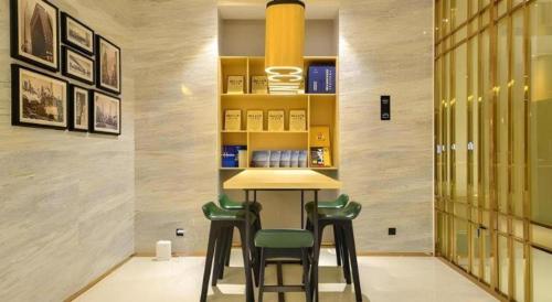 a bar in a room with two stools at a counter at City Comfort Inn Lijiang Ancient Town in Lijiang