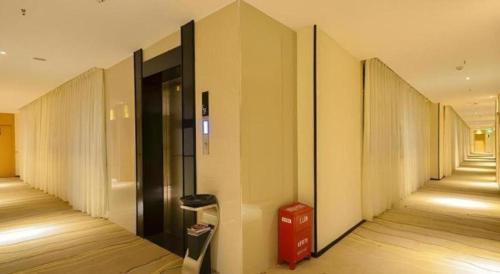 a hallway of an office building with a trash can at City Comfort Inn Lijiang Ancient Town in Lijiang