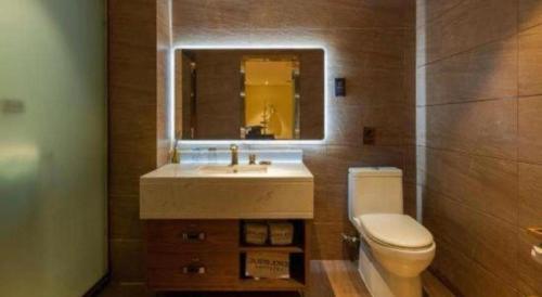 a bathroom with a sink and a toilet and a mirror at James Joyce Coffetel Kunming Railway Station Huancheng Nan Road Metro Station in Kunming