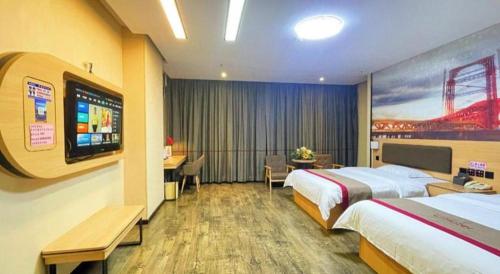 a hotel room with two beds and a flat screen tv at Thank Inn Plus Hotel Guangdong Yunfu Luoding City Municipal in Yunfu