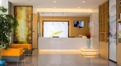 a lobby with orange furniture and a large window at GreenTree Inn Express Chuzhou Langya District Government Chuhe Road in Chuzhou