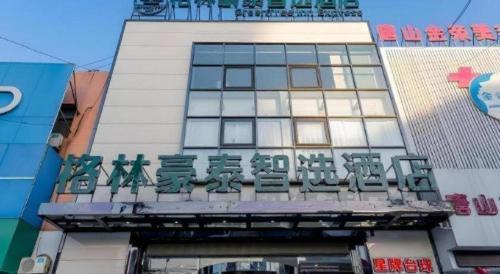 a building with a sign on the front of it at GreenTree Inn Express Hebei Tangshan Guyan District Xinguang Road in Tangshan
