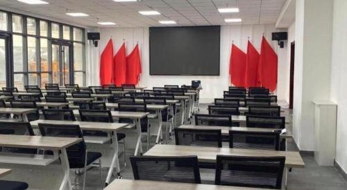 an empty classroom with desks and red flags at GreenTree Inn Express Datong High-Speed Railway Station Wanda Plaza Fangte in Datong