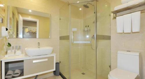 a bathroom with a shower and a sink and a toilet at VX Hotel Chengdu Shuangliu Airport Sainawei in Chengdu