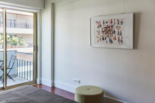 a bedroom with a bed and a picture on the wall at República Bed & Breakfast in Lisbon