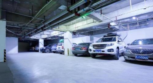 a parking garage with several cars parked in it at Green Tree Inn Tibet Lhasa Zhaji Temple in Lhasa