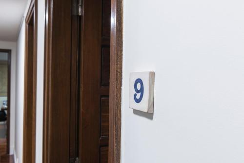 a door with a sign that says on it at República Bed & Breakfast in Lisbon