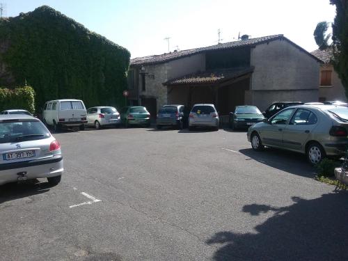 a bunch of cars parked in a parking lot at Gîte de Claire in Lectoure