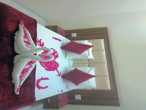 a reflection of a bedroom with pillows in a mirror at Hotel lucky guest house in Jhānsi