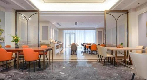 a dining room with tables and chairs in a building at Vienna Hotel Hangzhou East Railway Station West Square in Hangzhou