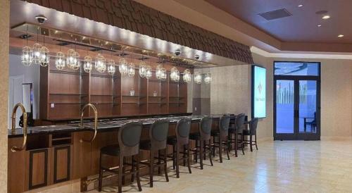 a bar with a row of chairs in a room at Ahern Hotel and Event Center in Las Vegas