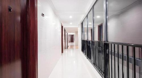 a hallway with black and white railings in a building at Poltton International Service Apartment Shanwei Urban District High-speed Railway Station in Shanwei