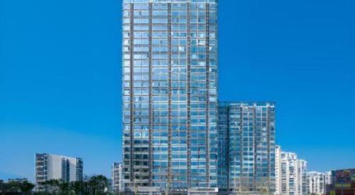 a tall building with many windows in a city at Poltton International Service Apartment Shanwei Urban District High-speed Railway Station in Shanwei