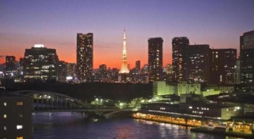 a city skyline at night with the eiffel tower at Ginza Bellevue Hotel in Tokyo