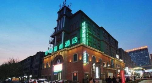 a building with green lights on the top of it at GreenTree Inn Luoyang Henan University of Science and Technology in Luoyang