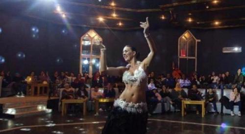 a woman dancing on the floor in front of a crowd at Djerba Holiday Beach in Midoun