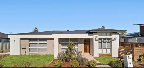 a house in the suburbs of melbourne at Brand new 5 star category home at RedHead beach in Redhead