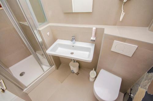 a bathroom with a sink and a toilet and a shower at Hostel Dvor in Split