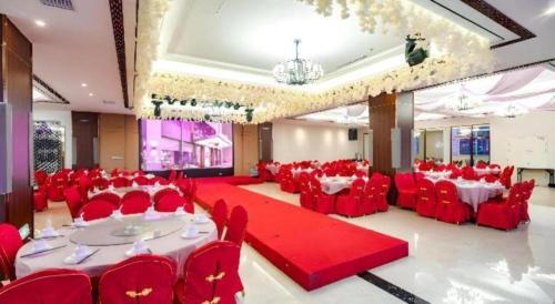 a large banquet hall with red chairs and tables at Borrman Hotel Changzhi Medical College Wulong Campus High-speed Railway South Station in Changzhi