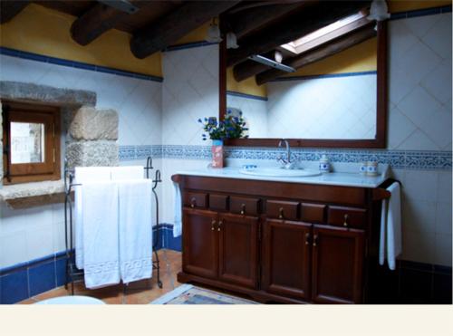 y baño con lavabo, espejo y toallas. en El Prau De Vidal, en La Puebla de Roda