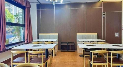 a classroom with tables and chairs and a large window at ZMAX Hotels Shenzhen Lianhuacun Metro Station in Shenzhen