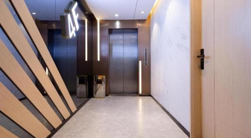 a hallway with a metal elevator in a building at ZMAX Hotels Shenzhen Lianhuacun Metro Station in Shenzhen