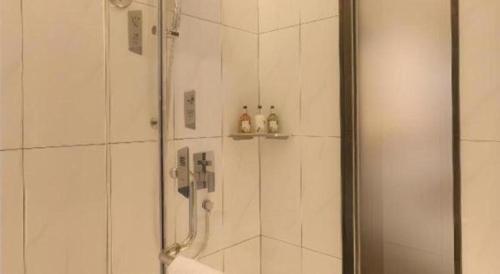 a bathroom with a shower with a glass door at Borrman Hotel Guilin Railway Station Two Rivers and Four Lakes in Guilin