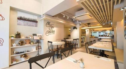 a restaurant with tables and chairs in a room at Metroplace Boutique in Hong Kong