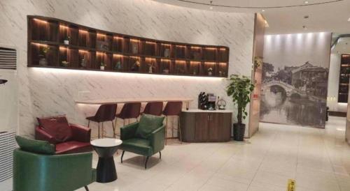 a lobby with chairs and a counter in a store at Jinjiang Inn Jiaxing South Lake in Jiaxing