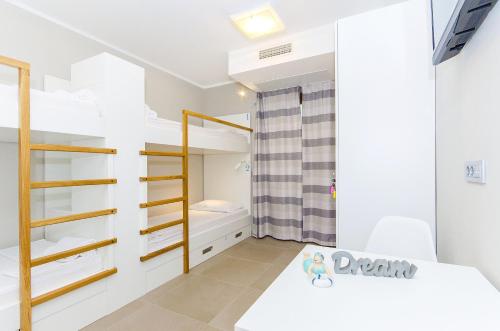 a small bedroom with a bunk bed and a bunk bed ladder at Hostel Dvor in Split